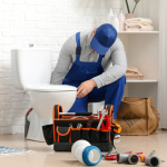man repairing toilet
